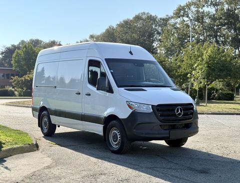 A 2020 Mercedes-Benz Sprinter van is parked at an angle showcasing its sleek white exterior and distinctive front grille design