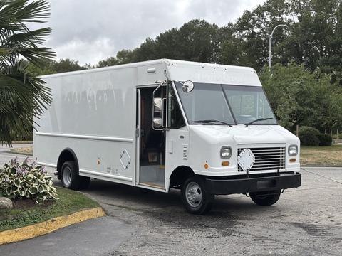 A white 2011 Ford E-450 box truck with a partially open door and no visible branding on the side