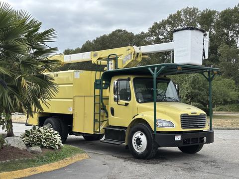A yellow 2014 Freightliner M2 106 truck with an elevated bucket system mounted on top and a canopy over the cab