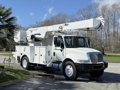 A 2011 International 4300 bucket truck with a white body and extended aerial work platform on top