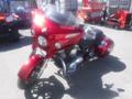 A red 2017 Indian Chieftain Elite motorcycle with a chrome engine and large windshield parked on a flat surface