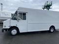 A white 2005 Freightliner MT45 Chassis truck with a rectangular cargo area and a single sliding side door