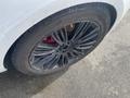 A close-up view of a black alloy wheel with a red brake caliper from a 2020 Land Rover Range Rover Sport