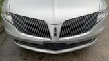 Front view of a 2013 Lincoln MKT showcasing its distinctive grille and sleek silver finish