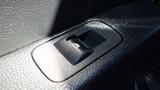 Close-up of the window control switch on the door panel of a 2017 Ford F-350 SD the switch has a sleek black design with a simple icon for window operation