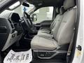 Interior view of a 2017 Ford F-150 showing the front seats with gray upholstery and a clean dashboard