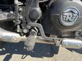 A close-up of the gear lever and foot peg of a 2022 Royal Enfield Himalayan motorcycle