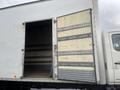A 2008 Hino 268 truck with an open rear door revealing an empty cargo area and wooden flooring inside