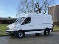 A 2012 Mercedes-Benz Sprinter van with a white exterior and black trim parked on a driveway