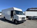 A white 2007 Ford Econoline delivery truck with an open side door displaying a simple, boxy design and large windshield