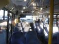 Interior view of a 2016 Chevrolet Express with rows of blue seats and overhead lighting