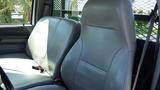 Interior view of a 2006 Ford F-650 featuring two leather seats with adjustable headrests and seat belts