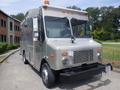 A silver 2007 Morgan Olson Workhorse W42 delivery truck with a flat front a black bumper and an orange light on top