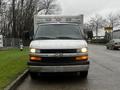 A white 2016 Chevrolet Express van viewed from the front with a black grille and headlights arranged in a rectangular pattern