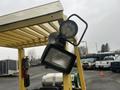 A 2000 Hyster 120 forklift with a yellow frame and two attached lights positioned at the top of the lifting mast