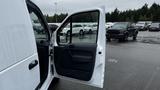 A 2012 Ford Transit van with the front passenger door open showcasing the interior details