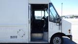 A 2006 Ford Econoline van showing the driver's side with an open door and view into the cabin and dashboard