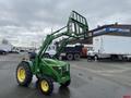 A 2003 John Deere 790 tractor with a front loader attachment in a green color featuring large tires and a compact design