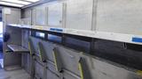 2011 Ford Econoline cargo van interior with metal shelving and compartments for storage