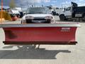 A 2010 Ford F-550 with a red Western snow plow attached to the front