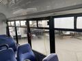 Interior view of a 2018 Chevrolet Express with blue seats visible and large windows allowing light into the vehicle