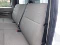 A beige upholstered rear seat with seatbelt in a Ford F-450 SD