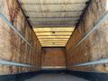 Interior view of a 2013 International 4300 box truck showing the wooden walls and ceiling of the cargo area