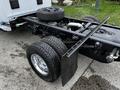 A 2018 RAM 3500 truck chassis with heavy-duty wheels and tires visible on the rear axle along with a spare tire mounted in the truck bed