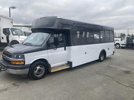 2018 Chevrolet Express bus with a black and white exterior and large side windows