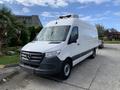 A 2019 Mercedes-Benz Sprinter van with a white exterior and a roof installation for refrigeration