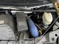 2015 Chevrolet Express engine compartment showing the battery air intake hose and various engine components