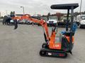 A compact orange and black excavator model 2024 AGT L12R with a hydraulic arm and tracks designed for digging tasks