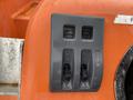 A control panel with two gray switches labeled "Pole" and "Spot" on an orange surface, featuring additional markings for operation