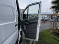 A 2016 Mercedes-Benz Sprinter van with its side door open revealing the interior handle and panel