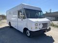 A white 2011 Ford Econoline delivery truck with a large cargo space and a flat front design