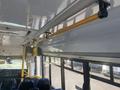 Interior view of a 2017 Chevrolet Express showing seating and overhead grab bars