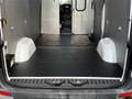 Interior of a 2017 Mercedes-Benz Sprinter van showing a spacious cargo area with black rubber flooring and molded wheel wells