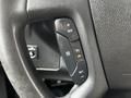 Steering wheel controls of a 2017 Chevrolet Express featuring buttons for cruise control resume set and a warning light