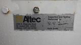 A weathered inspection and testing label from Altec affixed to a 2005 International 4300 showing contact information and signatures