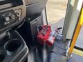 A red toolbox and a fire extinguisher are placed near the door of a 2018 Chevrolet Express van's interior