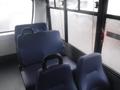 Interior of a 2016 Chevrolet Express showing blue vinyl seats arranged in a row with grab handles