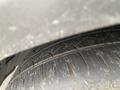 Close-up of a worn tire on a 2021 Lexus NX 300 showing tread patterns and dirt on the surface