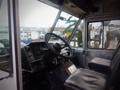 Interior view of a 2003 Freightliner MT45 Chassis showing the steering wheel dashboard and driver's seat