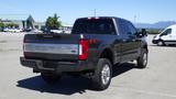 A 2017 Ford F-350 Super Duty truck with a black exterior and FX4 badge parked at an open location, showing its rear and side profile