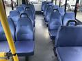 Interior of a 2017 Chevrolet Express featuring rows of blue upholstered seats arranged in a spacious layout