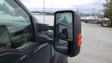 2008 Ford F-450 Super Duty with a close-up view of the side mirror reflecting another vehicle in the background