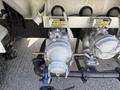 A close-up view of the diesel fuel system on a 2009 International 7500 featuring two fuel filters and connections with labels indicating kerosene and diesel usage