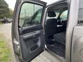 Interior view of a 2013 Chevrolet Silverado Hybrid with the rear door open showing the back seat and armrest area