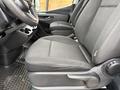 Interior view of a 2019 Mercedes-Benz Sprinter showing the driver's seat and the passenger seat with black fabric upholstery and a console in between