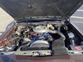 Engine compartment of a 1982 Mercury Grand Marquis featuring a large air filter a complex arrangement of hoses and wires and various engine components visible